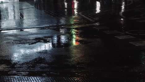 drizzle puddles and night urban lights reflecting on the road