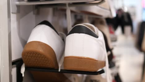 white sneakers with brown soles on display in a shoe store