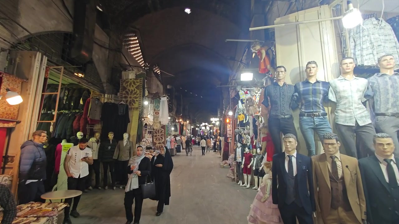 People Walking Through a Traditional Covered Bazaar at Night