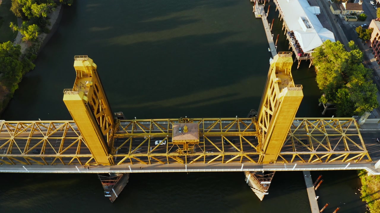 Drone Aerial Close Lock Off View of Sacramento Tower Bridge Traffic at Golden Hour - (4K UHD)