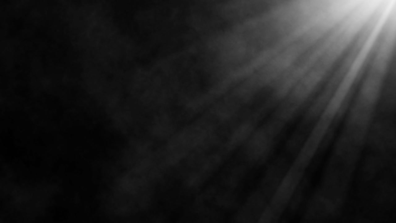Dramatic light rays streaming through billowing smoke on black background for atmospheric cinematic video presentations and moody visual content loops