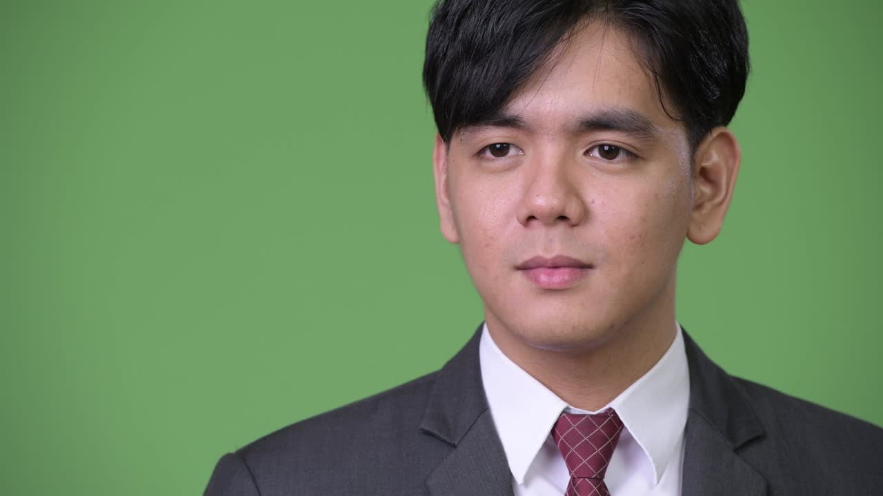 젊은 잘생긴 아시아 사업가가가 충격을 받았습니다.