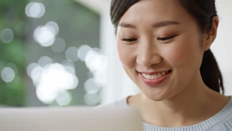captivating moments of a young woman engaged in a lively online interaction while smiling and connecting through her laptop in a bright, inviting environment