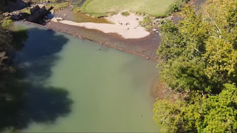 Aerial-fly-over-of-suburban-waterfall-and-creek-in-Old-Town-Helena,-Alabama