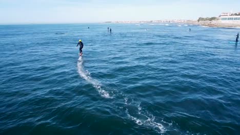 man riding an efoil on the ocean