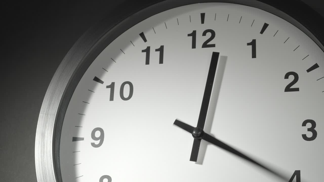 Clock Face in Time Lapse on Dark Grey Wall