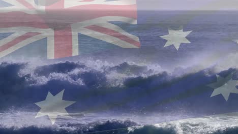 digital composition of australia flag waving against aerial view of waves in the sea