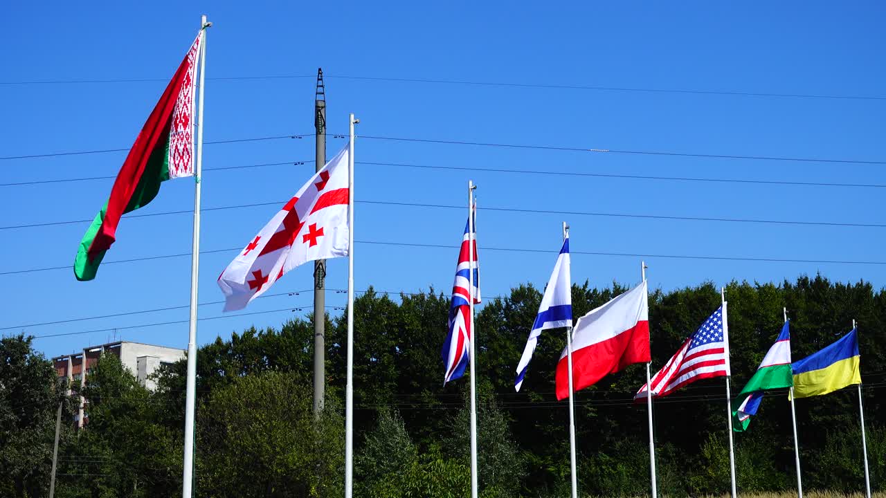 Flags of Belarus, Georgia, Great Britain, Israel, Poland, USA, Uzbekistan and Ukraine on flagpoles