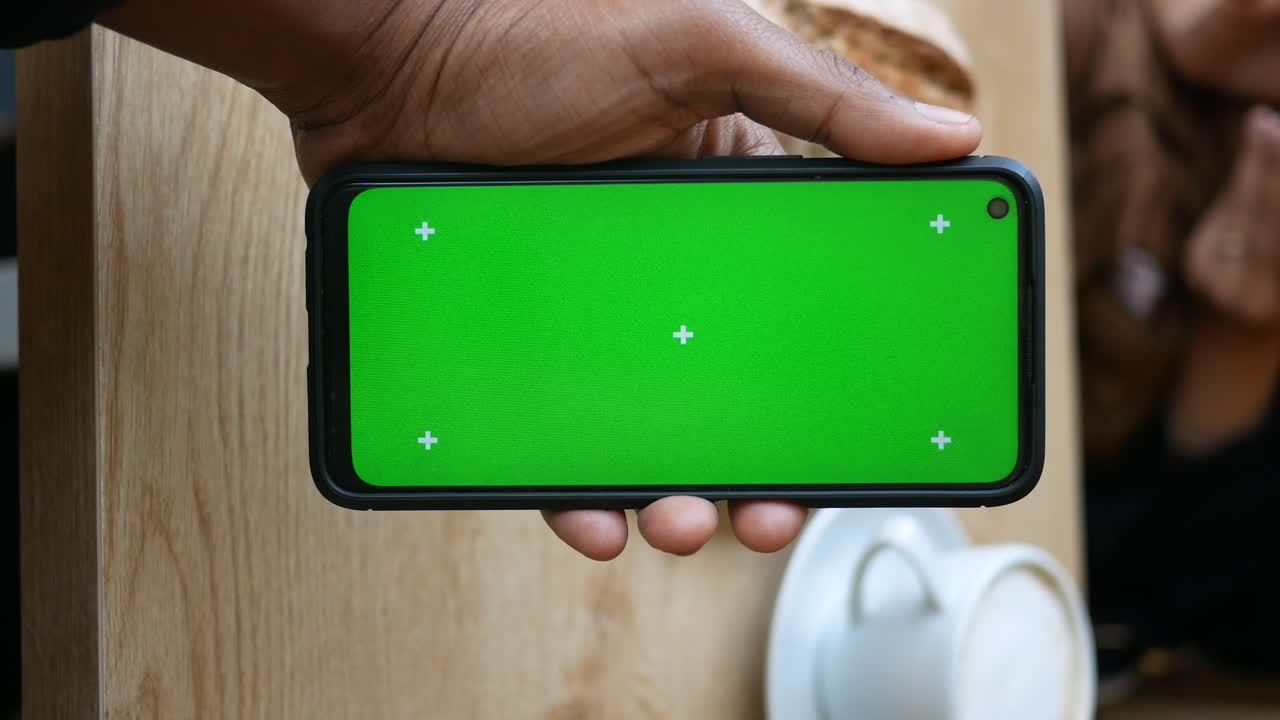 Smartphone with Green Screen in Hand