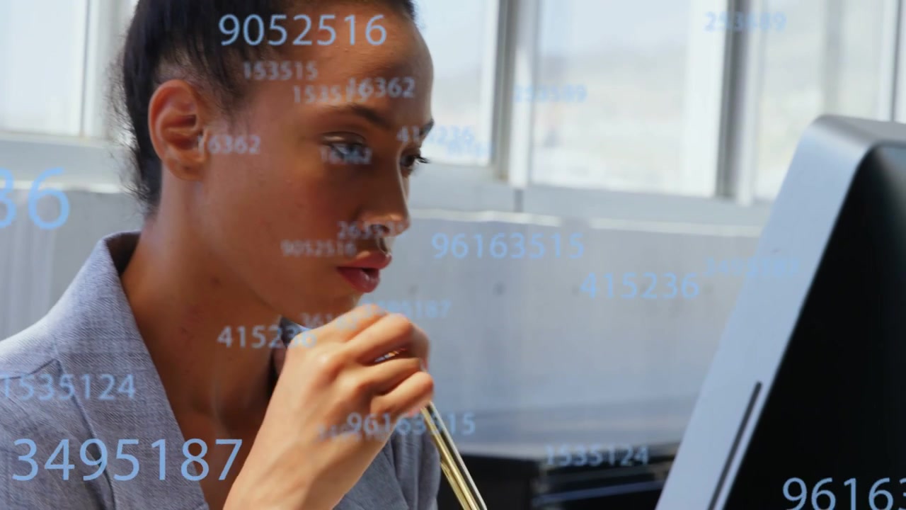 Woman analyst typing at glass desk, pausing and analyzing screen as moving finance digits appearing
