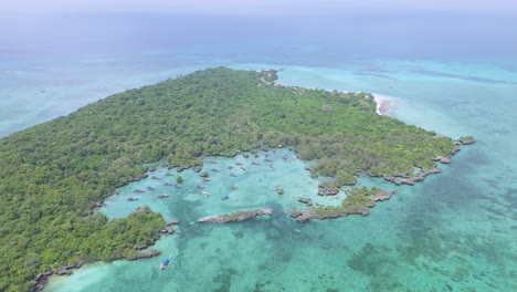 Drone-reveal-snorkel-tour-tourist-boats-in-teal-Kwale-island-lagoon-in-Zanzibar