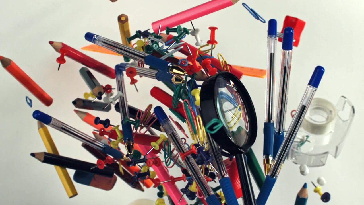 Colorful Office and School Supplies Floating Against a White Background