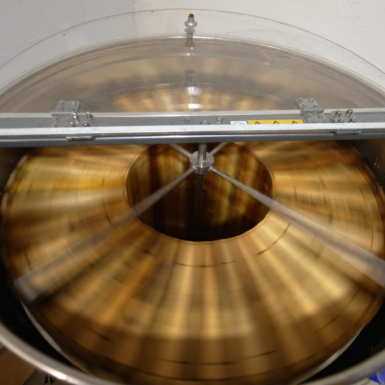 Centrifuge machine rotating honey frames to extract honey from cells. Beekeeper's equipment for collecting honey harvest. Top view