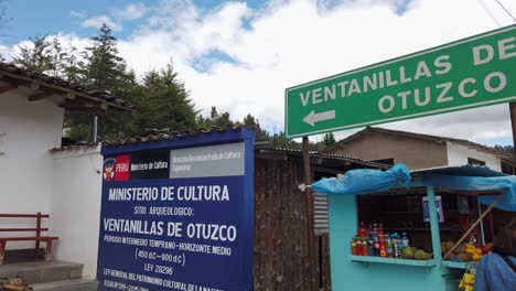 signs at the entrance of ventanillas de otuzco in otuzco, peru. pan left, slow motion