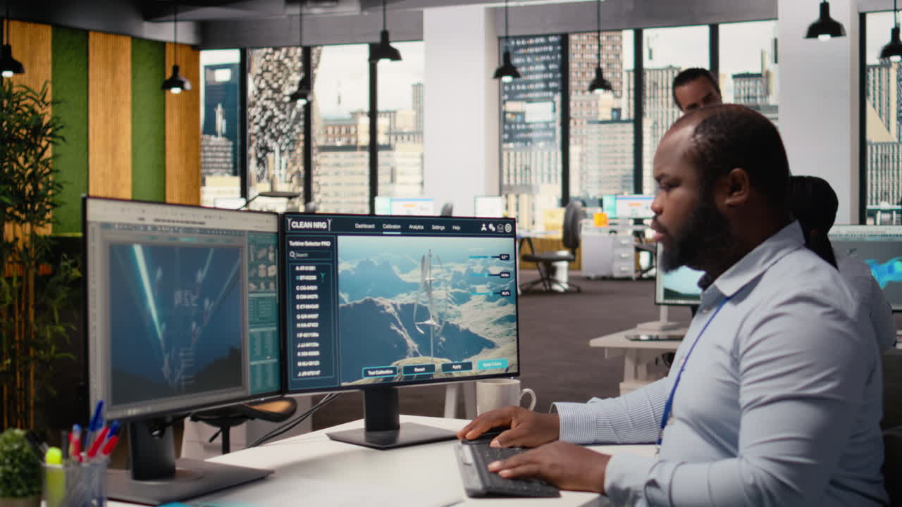 Employee Using Electric Grid With Wind Farm Layout Modeling Software