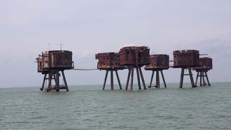 the maunsell forts old world war two structures stand rusting on stilts in the thames river estuary in england