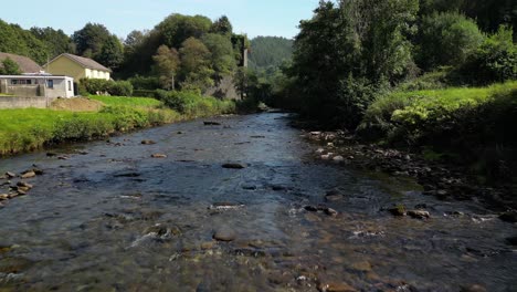 An-aerial-drone-shot-over-a-Welsh-river-to-a-beautiful-valley