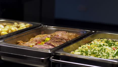 restaurant guests select food from a buffet