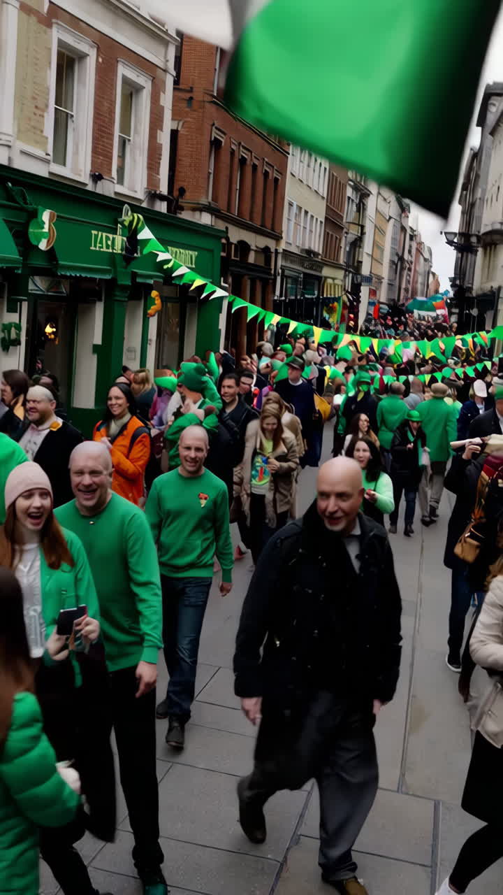 A vibrant street parade featuring a large crowd in green attire and a prominent Nigerian flag