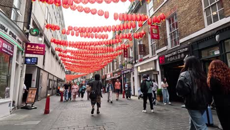 people walking under lanterns in chinatown, london