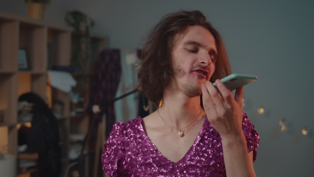 Man in sequin dress talking on cellphone