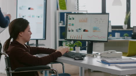 Immobilized-woman-checking-financial-reports-typing-at-pc