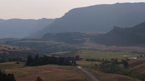 a scenic road winds through the mountainous sunlight basin in wyoming during early evening