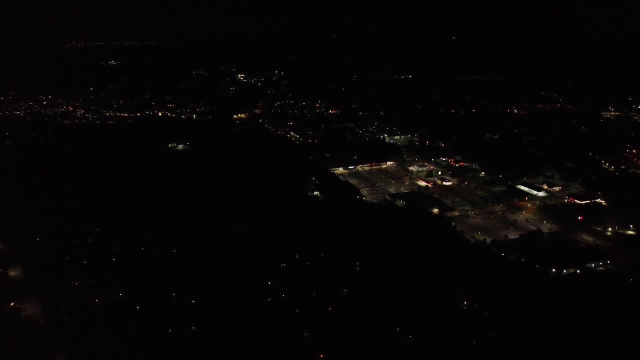 Flying over small town at night