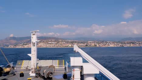 tracking wide shot of mainland and mediterranean as ferry pulls away from port