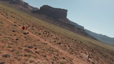 two friends hiking in indian creek to take some photos and videos