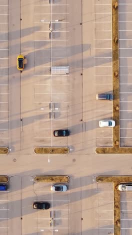 cars parked in neat rows during sunset in riga, latvia, vertical overhead framing, tracking left