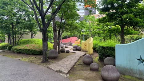 playground area with colorful walls and trees in a peaceful park on a cloudy day