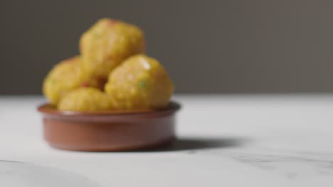 Close-Up-Of-Laddoo-In-Bowl-Celebrating-Muslim-Festival-Of-Eid