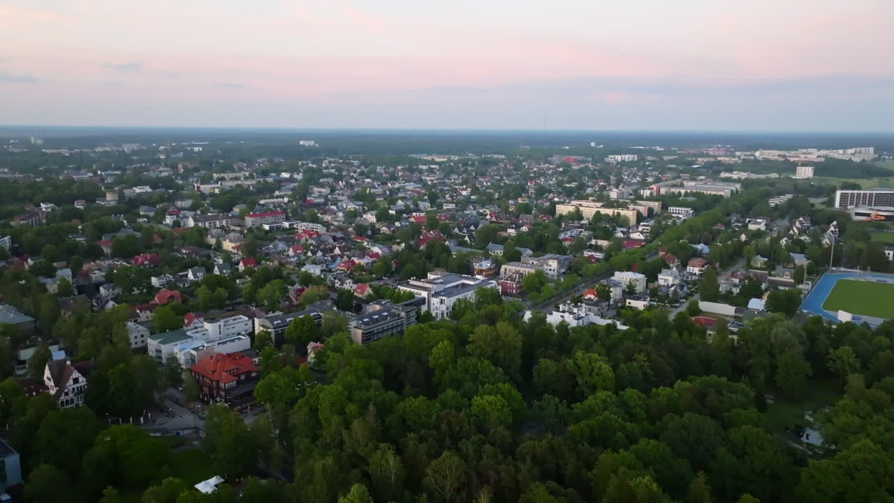 Establishing drone shot of the Parnu city, colorful summer dusk in Estonia