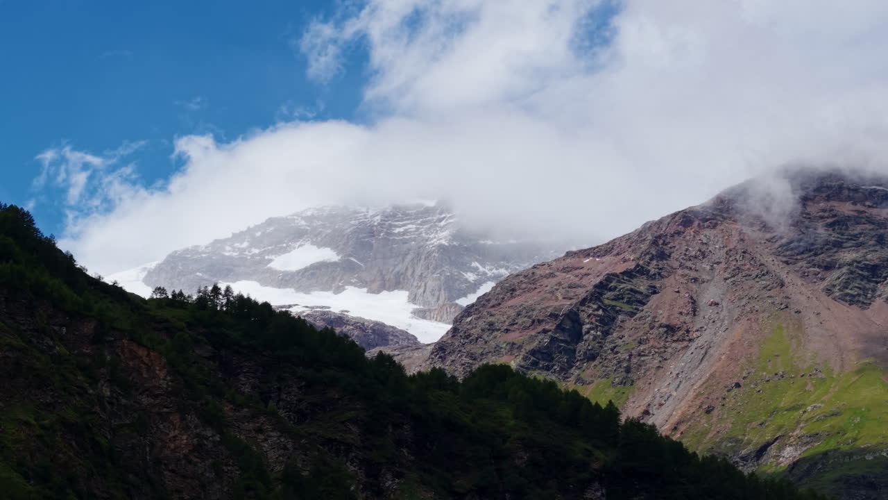 Majestic Snowy Mountain Peak Covered by Clouds in Swiss Alps Range