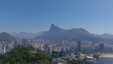 Aerial-footage-showing-Botafogo-in-Rio-de-Janeiro-with-the-Jesus-statue-in-the-background-in-the-hazy-light-of-the-morning