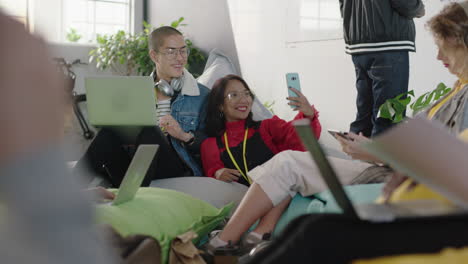 beautiful-young-asian-business-woman-using-smartphone-friends-taking-photo-together-sharing-friendship-on-social-media-enjoying-mobile-phone-camera-technology-in-diverse-office