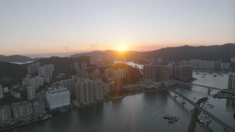 Sunset-above-the-mountains-rage-behind-urban-concrete-jungle