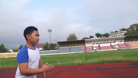 asian boy running at stadium