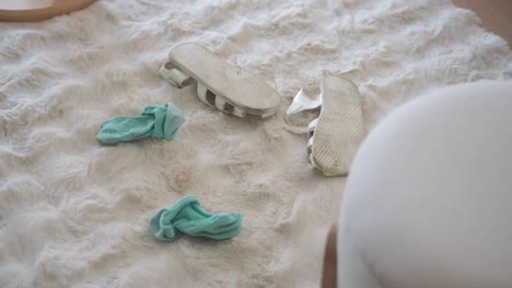 socks and sandals on a fluffy white rug