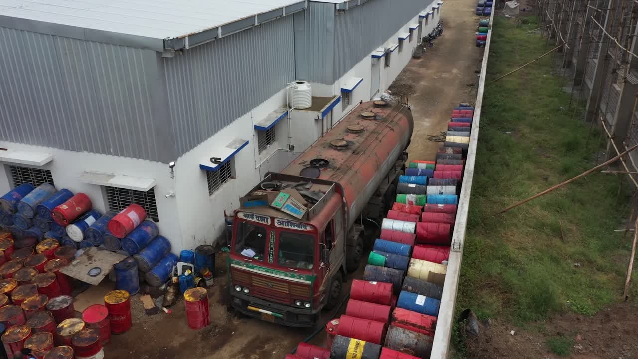 aerial drone view of truck is unloading a lubricant oil tanker, industry 5.0