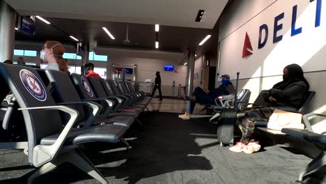 caucasian father and  child son wearing mask in raleigh airport during pandemic holiday thanksgiving travel