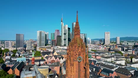 4k aerial drone video of the clock tower of the historic kaiserdom st. bartholomäus church in downtown frankfurt, germany