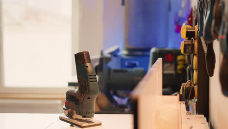 electric router used for cutting wood in carpentry studio, panning shot