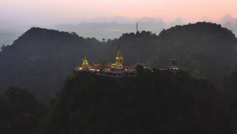 Buddhist-Tiger-cave-temple-with-golden-Buddha-statue-in-Thai-mountains