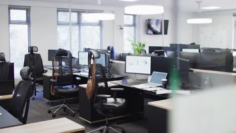 General-view-of-empty-modern-office-with-multiple-computers,-slow-motion