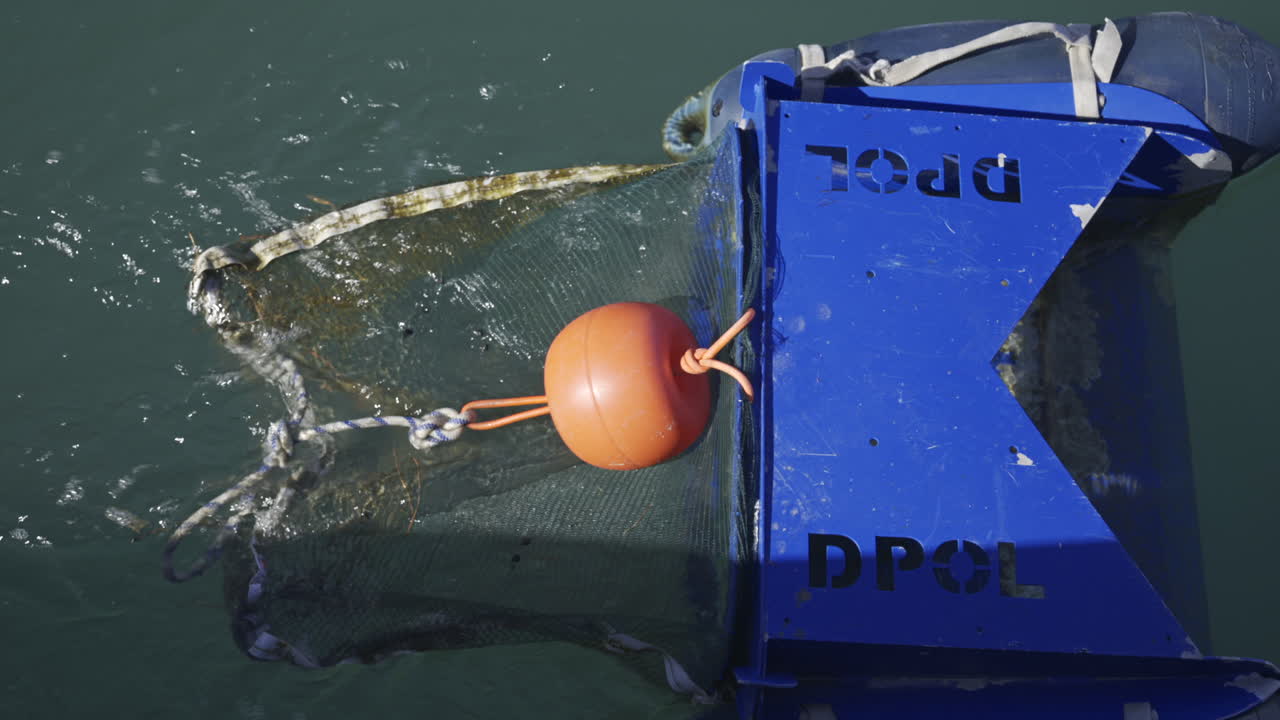 Villeneuve-Loubet, France - June 7, 2025: Close up of a floating marine debris collection device in the water