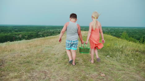 a girl and a boy carry baskets of berries together