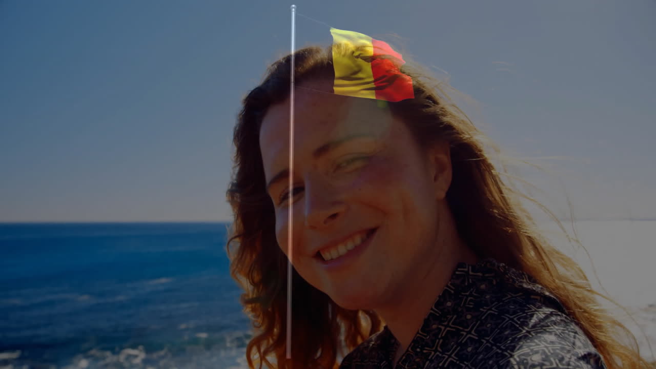 Animation of woman by ocean with Belgian flag overlay on her face