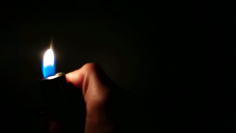 closeup of a lighter flame in pitch black